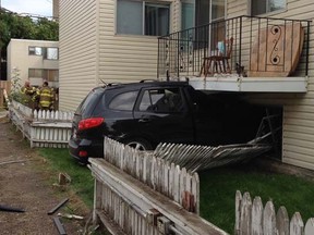 A black SUV crashed through the window of an Edmonton apartment building and into a basement suite at 10955 84 St. on Aug. 25, 2014.