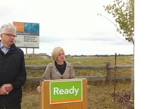 Edmonton-Whitemud NDP candidate Dr. Bob Turner, left, and NDP leadership candidate Rachel Notley stand in front of a field in the Terwillegar neighbourhood, near Maynard Way and Mactaggart Drive, where the Conservative government promised a school would open in 2016.