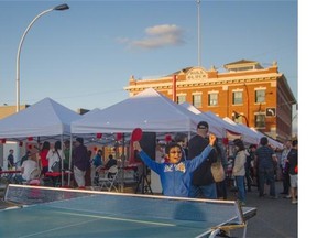 Nalin Bhatnhgar celebrates winning a point in Ping-Pong at the 97th Street Night Market on Saturday, Aug. 23, 2014.