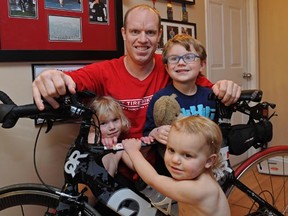 Triathlete Colin Hackett, who was diagnosed with cancer after changing his lifestyle, poses with three of his four children, Calliah, left, Cambrey (front) and Kelland.
