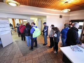 People line up early to vote in the Alberta provincial election at the Ritchie polling station in Edmonton on April 23, 2012.