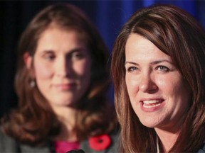 Wildrose leader Danielle Smith, right, smiles as she makes her concession speech, with Sheila Taylor, Calgary-West candidate at the campaign headquarters in Calgary, on Monday.