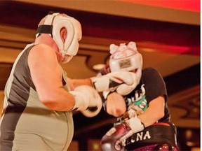 Nick Lees scores a punch against Jelena Mrdjenovich during their Beauty and the Beast fight at the Chateau Lacombe.