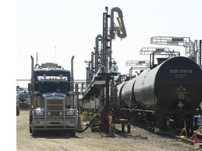 A semi unloads oil to be loaded into a rail car with oil at Canexus' operation in Bruderheim, Alberta