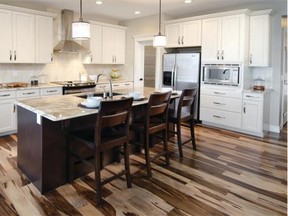 The open kitchen in the Arlington III is tied to the adjoining great room with show-stopping hardwood. It also features granite countertops and stainless steel appliances.