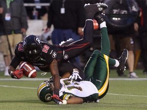 Ottawa Redblacks defensive back Reggie Jones causes a pass to Edmonton Eskimos wide receiver Shamawd Chambers to fall incomplete during a Canadian Football League game at TD Place Stadium in Ottawa on Aug. 15, 2014.