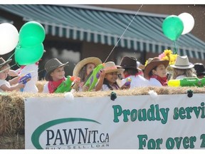 The Pawn It float crew was trigger happy during the Beverly Centennial Parade on Aug. 23, 2014.
