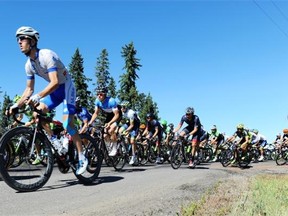 The peloton of riders round a corner near Cooking Lake in Stratcona County during Stage 4, 164 km from Edmonton Northlands to Sherwood Park at the 2014 Tour of Alberta in Edmonton, September 6, 2014.