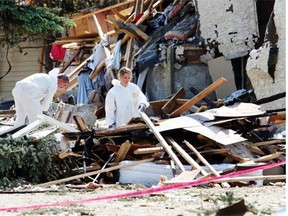 Police forensic officers searched through houses damaged in an explosion in Lago Lindo in Edmonton in June 2010.