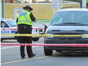 Police investigate after a man was hit by this van in the pedestrian crosswalk on Jasper Avenue and 122nd Street during the afternoon rush hour on Oct. 23, 2014.