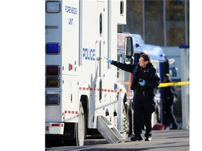 Police investigate an early-morning stabbing of a man on an ETS bus at the Coliseum transit station in Edmonton on Oct. 17, 2014.