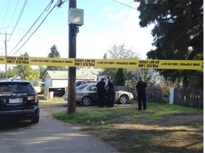 Police officers investigate a dog attack in central Edmonton’s Spruce Avenue neighbourhood last month.