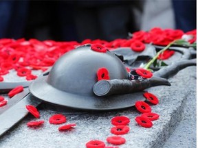 Poppies sit on the Tomb of the Unknown Soldier after Tuesday morning’s Remembrance Day ceremony in Ottawa. An estimated 50,000 or more people lined the streets around the War Memorial Monument to participate.
