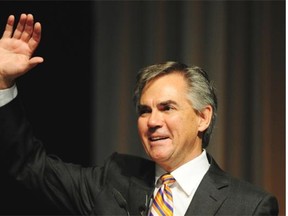 Jim Prentice waves from the stage after the results of his victory are announced at the PCAA in Edmonton, September 6, 2014.