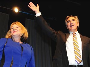 Jim Prentice and his wife Karen wave from the stage after the results of his victory are announced at the PCAA in Edmonton, September 6, 2014.