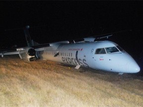 A propeller is seen lodged into the side of the plane that had a rough landing at Edmonton International Airport on Nov. 6, 2014.