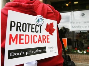 A protester’s sign is seen during a rally against the opening of the Copeman Healthcare Centre clinic in Calgary in 2008.