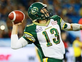 Quarterback Mike Reilly of the Edmonton Eskimos makes a pass as his team faces the Toronto Argonauts during their game at Rogers Centre on October 4, 2014 in Toronto.