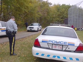 RCMP cars at Red Willow Trail behind Minor League Ball Diamonds.