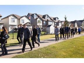 Regional mayors and councillors are examining how to create more affordable housing in Edmonton. They are seen here touring a new area in Spruce Grove that has been designed with this in mind.