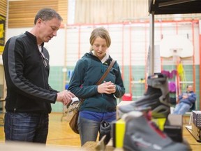 Reporter Otiena Ellwand shops for cross-country ski boots with the help of Track ‘N Trail owner Bob Schilf at a recent ski swap in the gym at Gold Bar Elementary School.