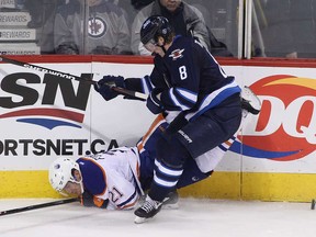 Edmonton captain Andrew Ference is overwhelmed by Jacob Trouba in a microcosm of another losing night for the Oil. The young Winnipeg rearguard had his way with the visitors, scoring 1 goal and 2 assists in the Jets'  3-2 overtime win.