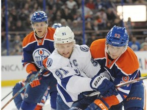 Ryan Nugent-Hopkins of the Edmonton Oilers ties up Steven Stamkos of the Tampa Bay Lightning during Monday’s National Hockey League game at Rexall Place.