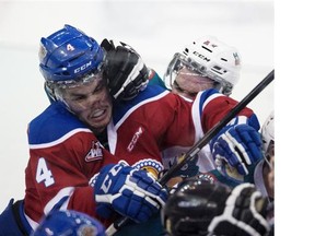 A scuffle begins in front  of the Edmonton Oil Kings bench between Blake Orban (4) and Kelowna Rockets Rodney Southam (17) during second period WHL action on December 16, 2014 in Edmonton.