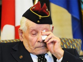 Second World War veteran Edmond Gagne, 93, wipes away a tear after being presented the French Legion of Honour medal during a ceremony at the Kipnes Centre for Veterans on Wednesday, Sept. 17, 2014.