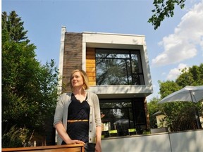Tegan Martin-Drysdale poses outside an infill house in Glenora at the July 2013 launch of the Infill Development in Edmonton Association. Edmonton needs to focus on density if it wants to truly be a big city, writes Greg Wandzilak.