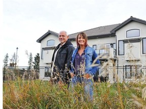 From left, Darcy and Cindy Bennett live in Villas on the Ravine, a luxury duplex condo in which the homes were built so the best features are in back to capture the view.