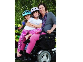 Shauna Paisley Cooper, a Stony Plain mom, became a quadriplegic in 2008 after a mountain biking accident. Now her seven-year-old twins Kyra, left, and Mya, centre, participate in bike races.