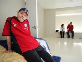 Shayne Whyte, 41, lives in this room at Red Deer’s Michener Centre home for mentally handicapped adults, which the province is closing in 2014. In the background of this May 9 photo are his parents Muriel and Ron Whyte.