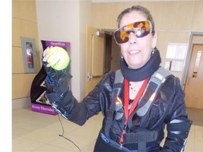 Shelley Lorimer, chair of the MacEwan University bachelor of science in engineering program tries on a “third-age” suit that mimics the movements and reaction time of an elderly person.