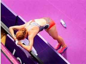 Paula Findlay crosses the women's triathlon finish line in tears at the London 2012 Olympic Games, August 04, 2012.