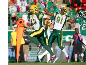 Edmonton Eskimos quarterback Mike Reilly runs for a touchdown as rookie wide receiver Devon Bailey celebrates during a Canadian Football League game against the Saskatchewan Roughriders at Mosaic Stadium in Regina on Oct. 19, 2014. Unfortunately, the touchdown was called back due to a penalty.
