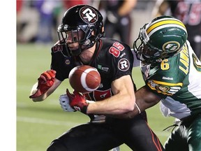 1. THE FUMBLE THAT LOST THE GAME FOR THE REDBLACKS. Ottawa's Matt Carter gets the ball knocked out from his grip by Edmonton's Alonzo Lawrence near the 20-yard line with less than three minutes left in the game.  during the Ottawa Redblacks Friday night matchup against the Edmonton Eskimos at TD Place in Ottawa, August 15, 2014.  (Julie Oliver / Ottawa Citizen)