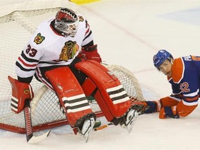 Blackhawks goalie Scott Darling falls on his net after Edmonton's Iiro Pakarinen knocked it over during first period action at the NHL pre-season game at Credit Union Centre in Saskatoon on Sunday.