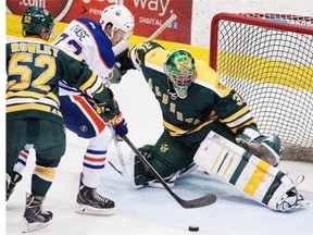 Edmonton Oilers rookie Greg Chase tries to put the puck past Golden Bears goaltender Kurtis Mucha during pre-season action at Clare Drake Arena on Sept. 16, 2014.