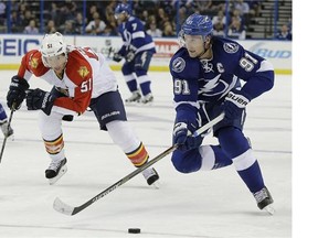 Tampa Bay Lightning center Steven Stamkos (91) gets ahead of Florida Panthers defenseman Brian Campbell (51) during the second period of an NHL preseason hockey game Saturday, Oct. 4, 2014, in Tampa, Fla.