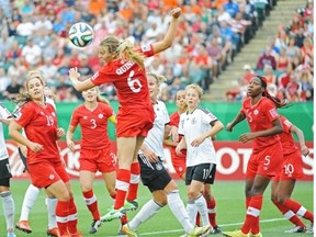Canada’s Rebecca Quinn tries to clear the ball after a German corner kick during the FIFA U-20 women’s World Cup semi-final in Edmonton on Aug. 16, 2014. Germany won 2-0.