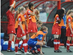A dejected Team Canada bench watches as the clock runs out at Commonwealth Stadium during the FIFA U-20 Women’s World Cup semi-final in Edmonton on Aug. 16, 2014. Germany beat Canada 2-0.