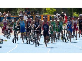 File photo. Cyclist come into the transition area as they prepare for the run in the Elite Men race at the ITU World Cup in Hawrelak Park on June 23, 2013 in Edmonton.