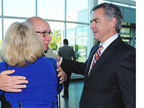 Stephen Mandel hugs Karen Prentice as she arrives with Jim at the PCAA elections leadership result announcement in Edmonton, September 6, 2014.