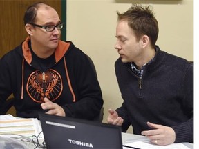 Stephen Nichols, right, of Aboriginal Affairs, helps Scott Ballandine fill out an application as part of a pilot project to help clients apply for treaty status on Thursday, Dec. 4. 2014.