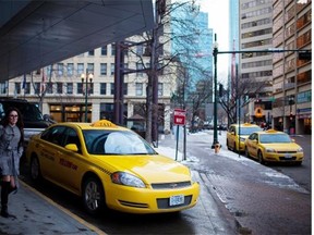 Taxi cabs wait for passengers outside The Westin in downtown Edmonton.