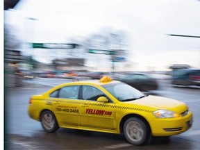 A taxicab takes a corner in downtown Edmonton on November 24, 2014.