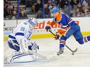Taylor Hall (4) of the Edmonton Oilers is stopped on a partial break by goalie Anders Lindback of the Tampa Bay Lightning at Rexall Place in Edmonton.