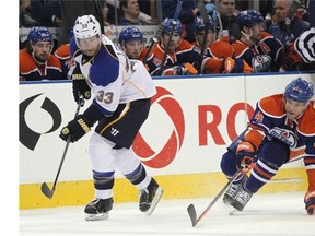 Taylor Hall of the Edmonton Oilers tries his best to intercept the puck as Jordan Leopold of the St. Louis Blues passes it across the ice during second-period action at Rexall Place.