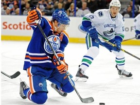 Taylor Hall (4)of the Edmonton Oilers,  tries to make a pass in front of the net against of the Vancouver Canucks at Rexall Place in Edmonton.